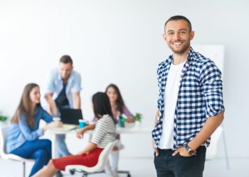 Successful businessman in front of diverse business team in modern office