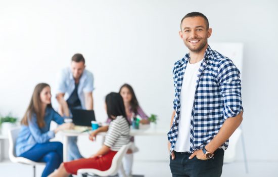 Successful businessman in front of diverse business team in modern office